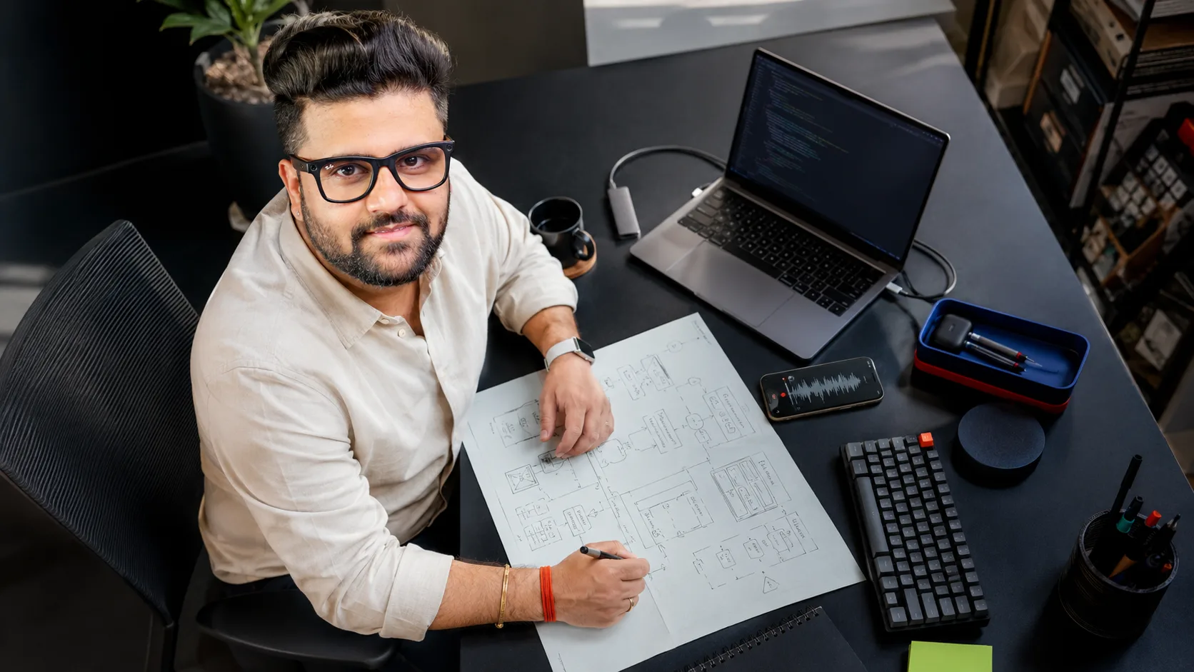 Sahil Khanna mapping an AI product workflow at his desk